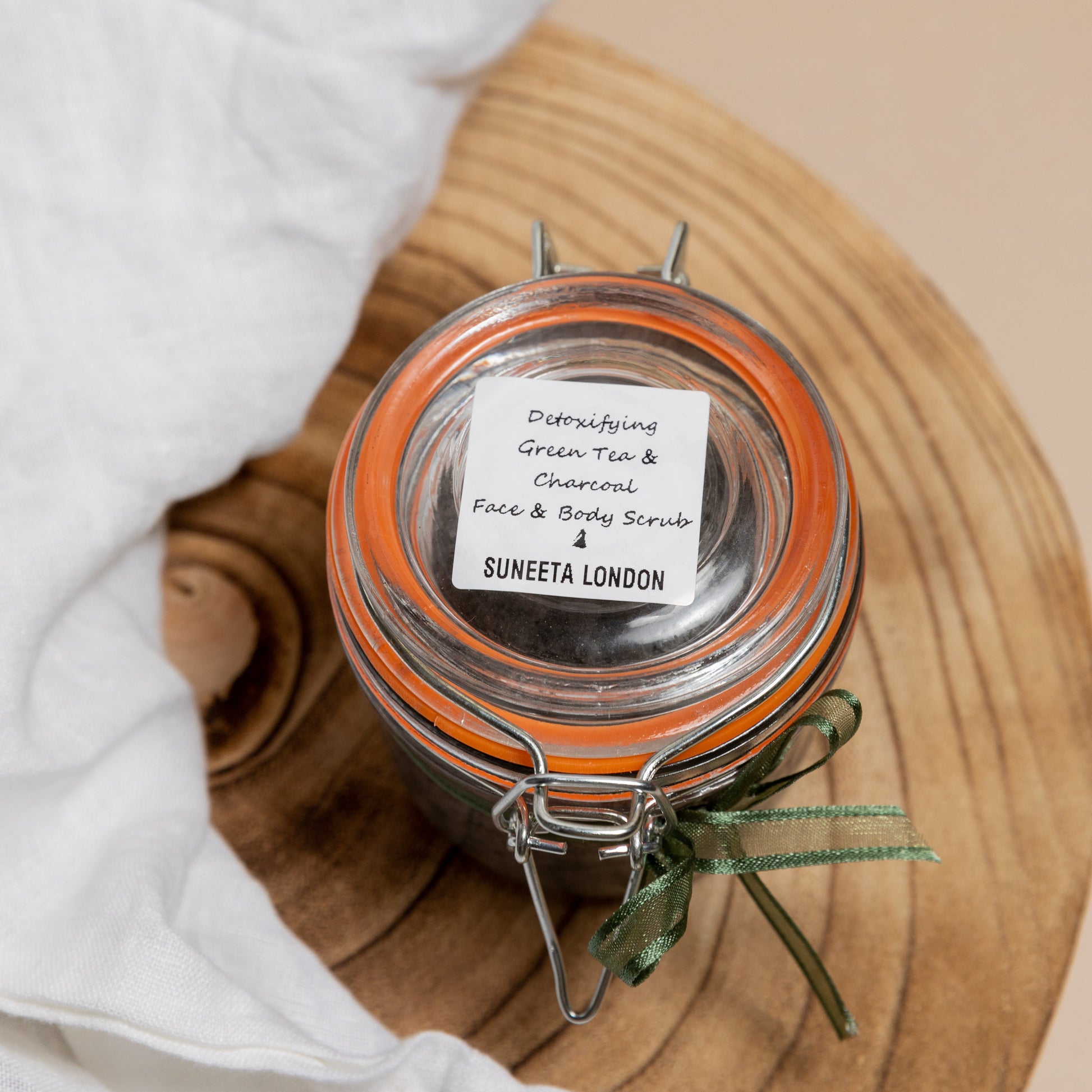 suneeta london's detoxifying charcoal and green tea face and body scrub. 250g glass kilner jar